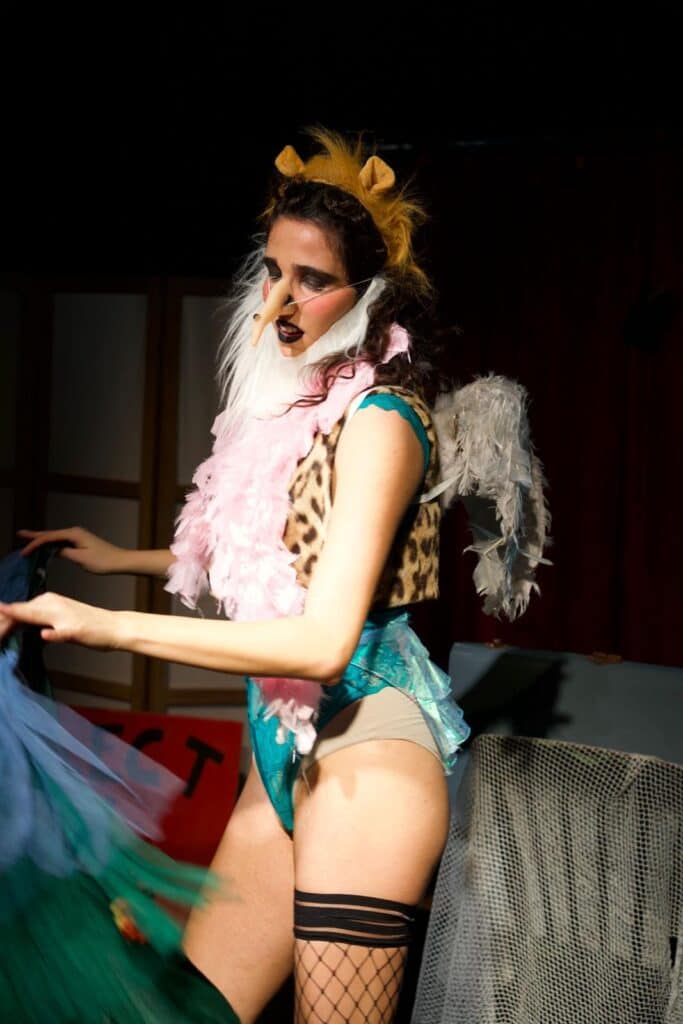 Sofia Natoli performing Babel Beast in an animal-inspired costume with wings and a long nose mask.