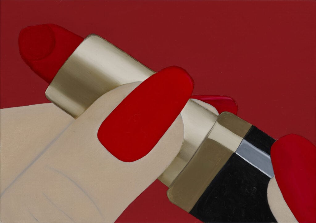 A close-up illustration of a hand with red-painted nails holding a tube of red lipstick against a matching red background.