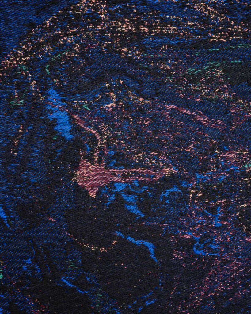 Abstract, textured image with swirling patterns of blue, pink, and purple specks on a dark background, resembling a cosmic or galaxy-inspired scene. The surface appears rough and woven, adding depth and dimension, artwork by Ben Kreukniet.