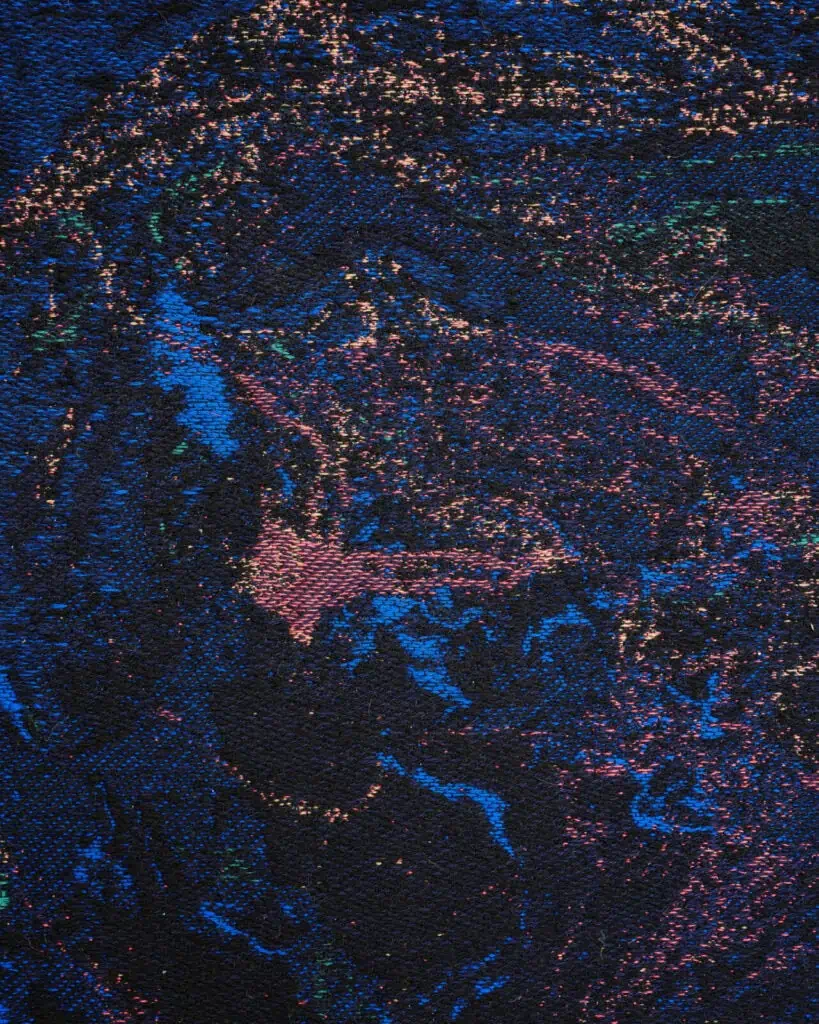 Abstract, textured image with swirling patterns of blue, pink, and purple specks on a dark background, resembling a cosmic or galaxy-inspired scene. The surface appears rough and woven, adding depth and dimension, artwork by Ben Kreukniet.
