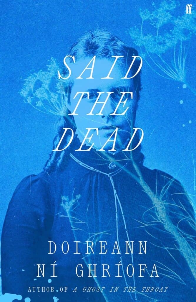 A blue-tinted book cover featuring an old-fashioned portrait of a woman with ethereal, ghostly wisps overlaying the image. The title “SAID THE DEAD” and author “Doireann Ní Ghríofa” appear on the cover.