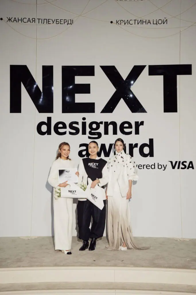Akbota Kapsalan and fellow winners on stage at the NEXT Designer Award ceremony powered by Visa, celebrating her success at Tashkent Fashion Week 2026.