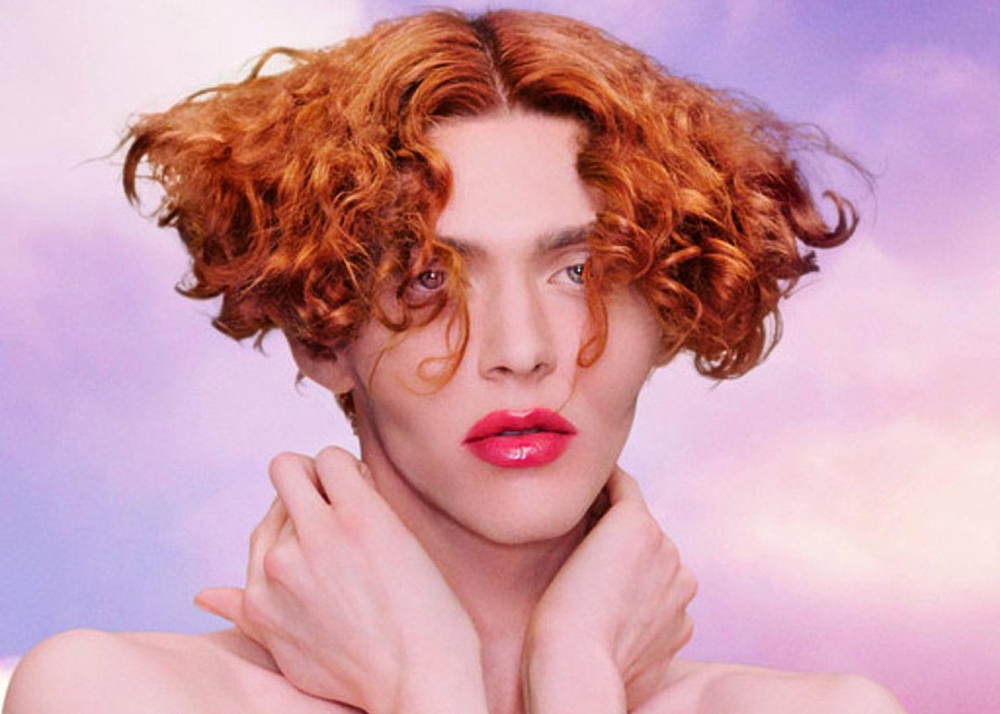 A person with red hair and pink lipstick, channeling the bold and vibrant style of SOPHIE.